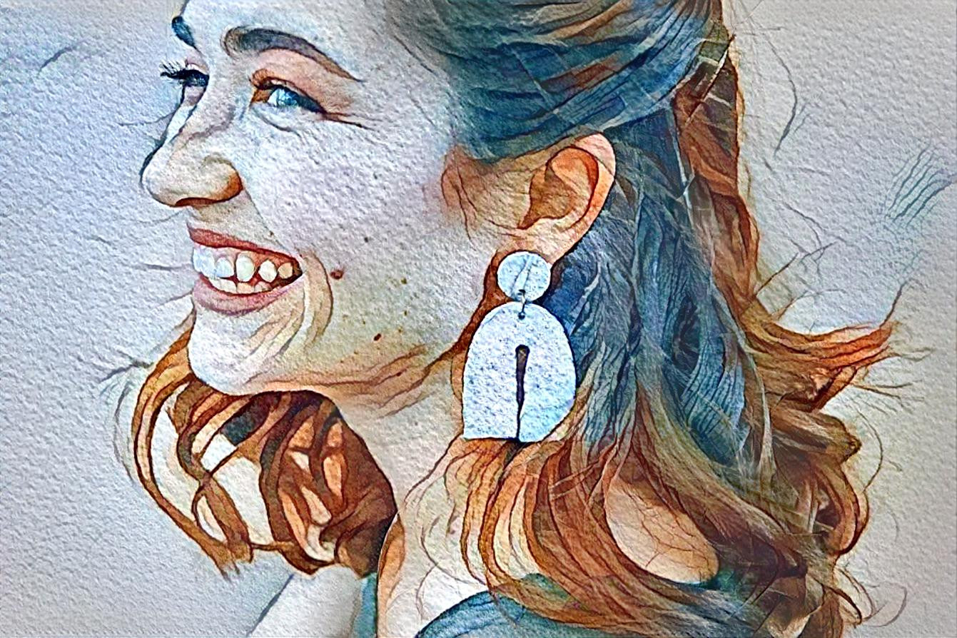 smiling woman with large earrings
