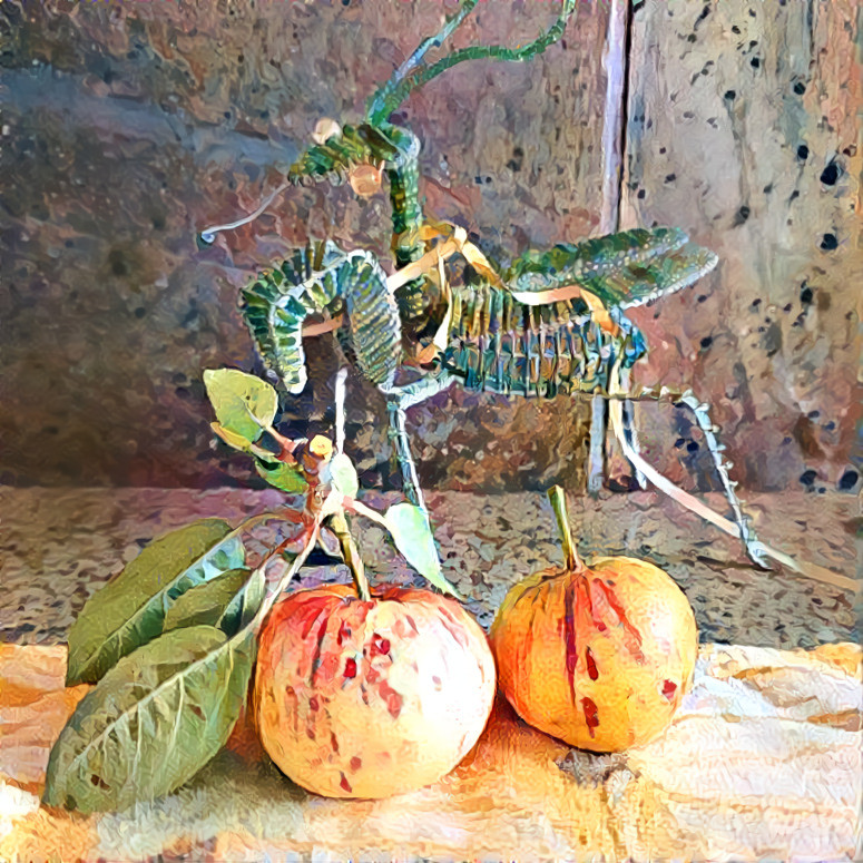 Toy praying mantis and garden apples 
