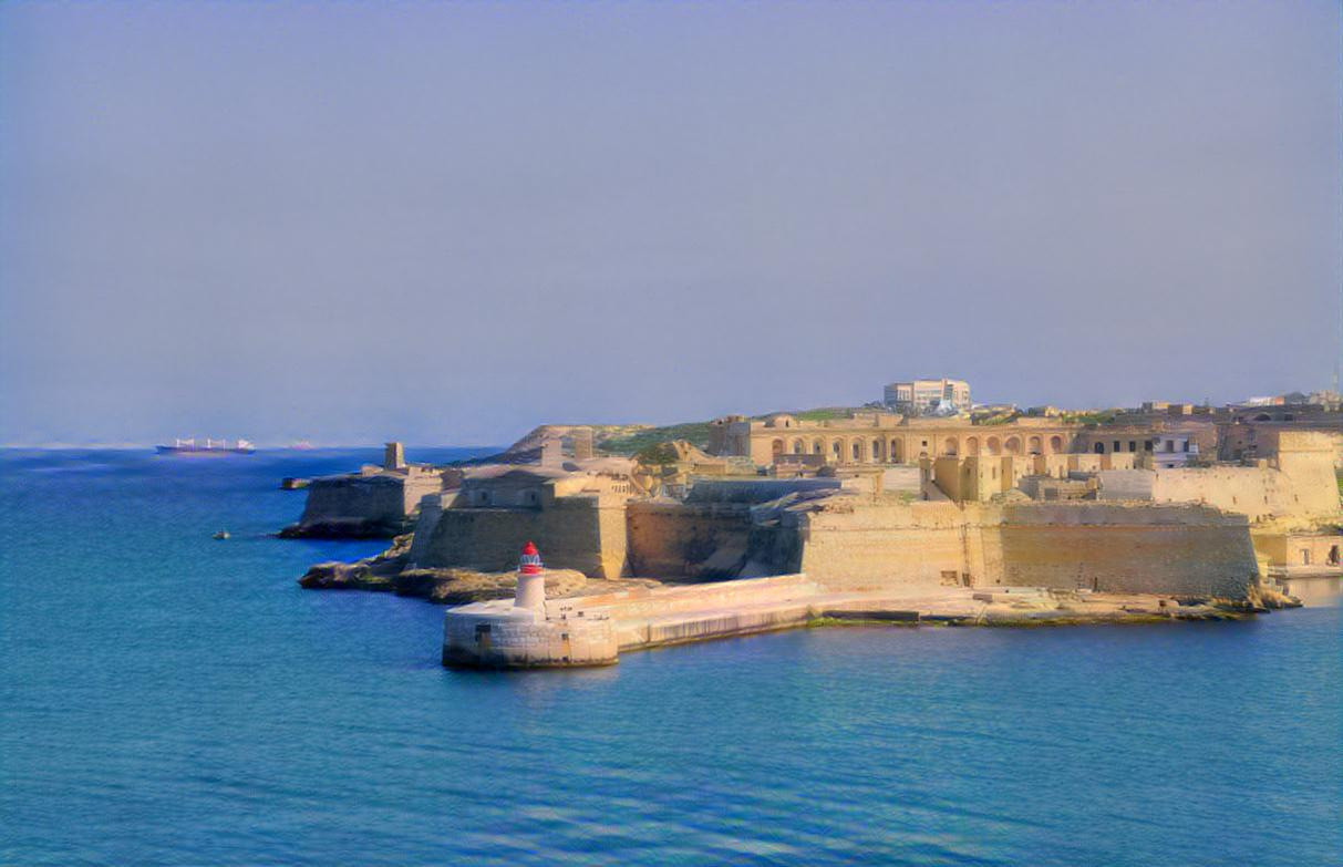 View of the harbor entrance and old medieval Ricasoli East Breakwater with lighthouse and Fort Ricasoli seen from Valletta, Malta